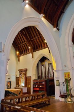 Northern transept, including the lectern (right) donated by the Moore family, the small pipe organ, and, in the NE corner of the transept, a painting of the Annunciation (see below).