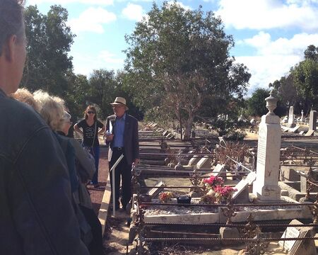 Don Whittington showing cemetery tourists Edwards' grave