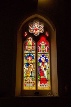 A window possibly showing two of the apostles. John is associated with a book (the Book of John) so that may be him on the right. If the figure on the left is holding keys, it would be St Peter.